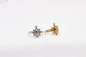 Close-up of vintage turtle rings in silver and gold finish with detailed shell texture