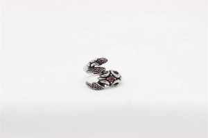 Detail of vintage silver scorpion ring with red stones and gothic oxidized finish