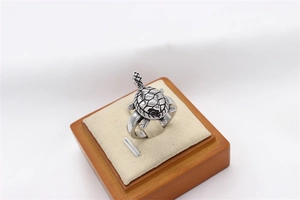 Detailed view of vintage stainless steel turtle ring with engraved shell patterns