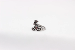 Macro view of vintage scorpion ring featuring red gemstones on stainless steel