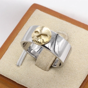 Punk style stainless steel men's ring with a gold skull relief in a silver wide band