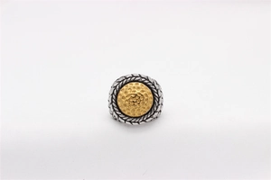 Detail of vintage two-tone titanium steel ring with rope texture and gold honeycomb center