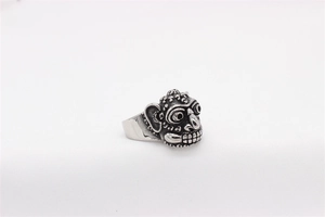 Detailed close-up of retro silver monkey mask steel ring with vintage finish and tribal carvings