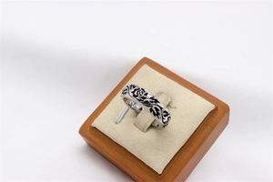 Macro shot of vintage silver ring with black rose floral patterns and Gothic design