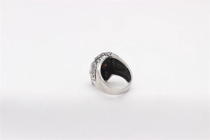 Detailed relief patterns and red gemstone on a vintage silver skull ring for men