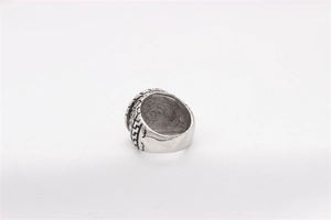 Macro detail of men's vintage titanium steel ring with black geometric Greek key pattern