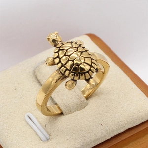 Vintage golden turtle ring in stainless steel with realistic shell texture on display