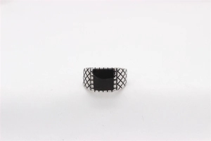 Detailed view of retro steel ring featuring black enamel inlay and diamond pattern texture