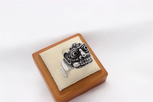 Macro detail of retro tribal monster relief on oxidized silver steel ring for men