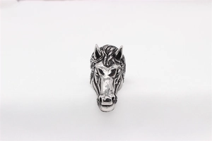Detailed close-up of retro silver horse head ring with vintage texture and carving