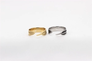 Detail of vintage feather rings in gold and silver steel with realistic engraved texture