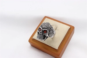 Close-up of vintage skull ring with red eye stones and intricate side engraving