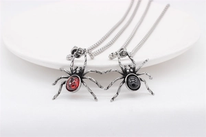 Detailed macro view of Gothic spider pendants with red and black inlaid gemstones