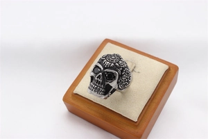 Macro view of vintage skull ring with intricate carvings and black gem eye sockets