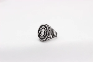 Macro detail of vintage eagle signet ring showing double-headed crest and scale texture