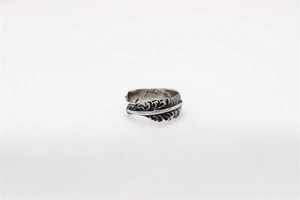 Detailed macro view of vintage feather texture on a stainless steel open ring