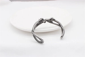 Close-up of vintage oxidized dragon scale cuff bracelet in retro punk style for men