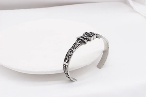 Detailed relief of skull and rose on vintage silver stainless steel cuff bracelet