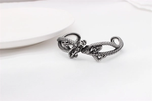 Detail of vintage silver dragon cuff bracelet featuring intricate scales and gothic style