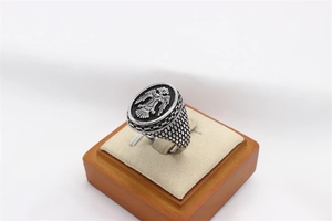 Macro detail of retro steel ring showing double-headed eagle relief and carved texture