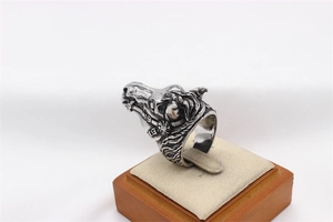 Detailed close-up of a vintage 3D white horse head ring in polished oxidized steel