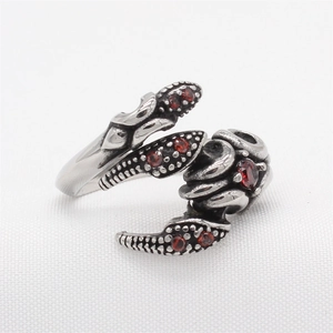 Vintage scorpion claw ring in stainless steel with red stones and dragon scale texture