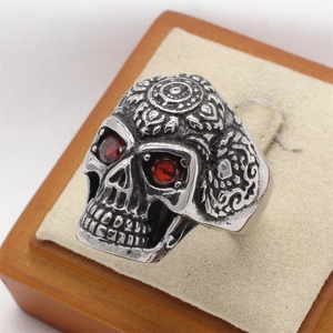 Retro skull ring for men with red gemstone eyes and detailed mandala carvings on silver band