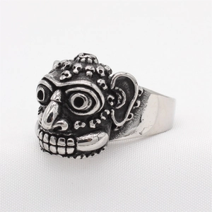 Vintage gothic tribal mask ring in oxidized steel with detailed relief carving