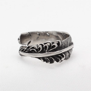 Vintage oxidized silver feather ring in punk style with detailed texture and open band