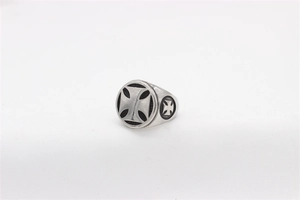 Macro detail of vintage stainless steel signet ring with engraved Maltese cross design