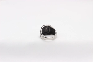 Detail view of vintage men's titanium steel signet ring with embossed side textures