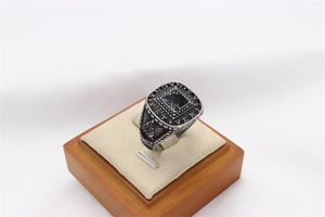 Detail of vintage steel ring with black stone, Latin engraving and Eye of Providence symbol
