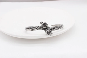 Detailed view of the intricate snake scale texture on a retro steel cuff bracelet