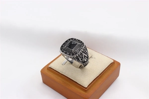 Macro detail of men's Masonic signet ring with black agate stone and Latin engraving