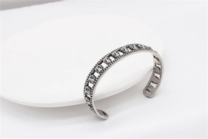 Macro shot of silver retro skull cuff bracelet with hollow gothic design and vintage finish