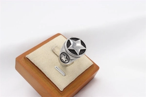 Detailed shot of retro stainless steel men's ring with 3D star reliefs and oxidized finish