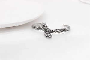 Detailed view of vintage silver snake scale texture on the steel open cuff bracelet