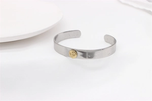 Close-up of vintage eagle emblem on matte silver titanium steel open bangle bracelet