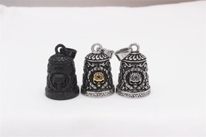 Detailed view of three punk rock stainless steel skull bell pendants in multi-color finishes
