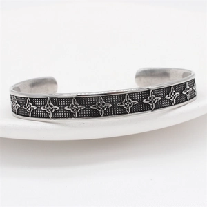 Retro Celtic cross pattern stainless steel cuff bracelet for men on white ceramic plate