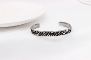 Detailed close-up of vintage Viking Celtic trinity knot pattern on steel cuff bracelet