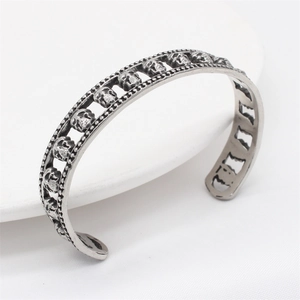 Retro gothic skull cuff bracelet in antique silver finish for men, 45-degree angle view