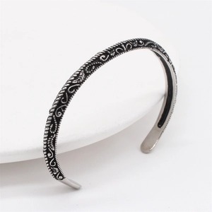 Retro stainless steel cuff bracelet with vintage floral carvings and oxidized finish
