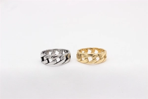 Detailed view of gold and silver stainless steel rings with classic Cuban link chain texture