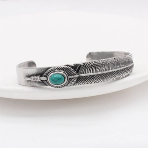 Vintage feather cuff bracelet in silver stainless steel with turquoise stone inlay