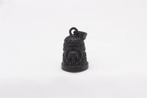 Detail of gothic bell pendant with embossed skull and intricate floral carvings