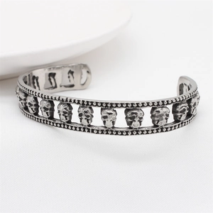 Retro stainless steel open cuff bracelet with 3D skull relief in antique silver finish