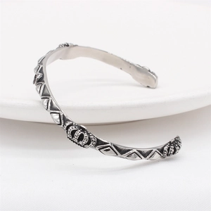 Retro stainless steel open cuff bracelet featuring crown relief and geometric patterns