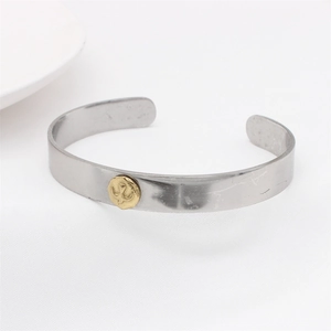 Retro eagle stainless steel open ring with round gold bird emblem on white background