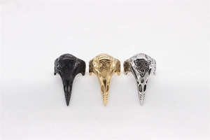 Detailed view of Viking raven skull rings with Celtic knots in black, gold, and silver